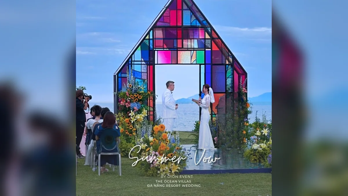 Colorful glass wedding ceremony backdrop with floral event styling